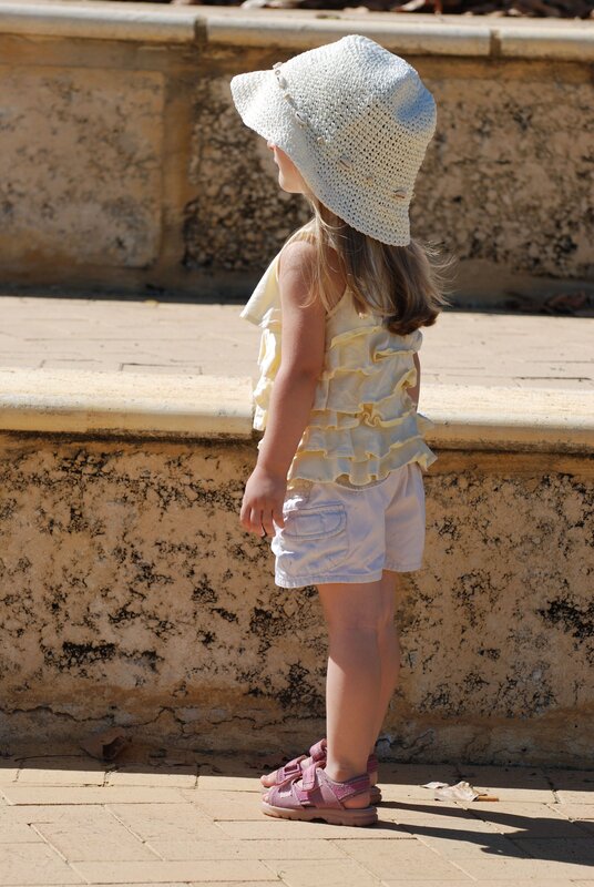 child in sun hat standing