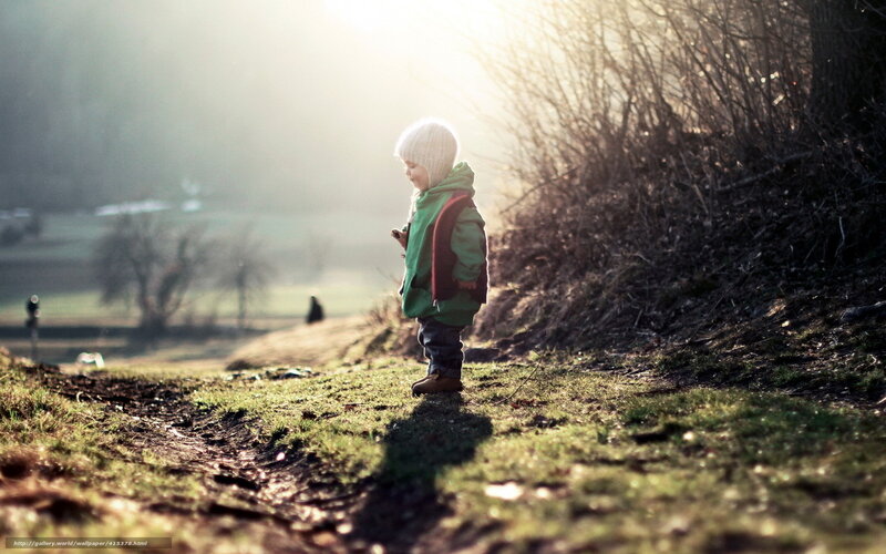 Child in sunlight on a path