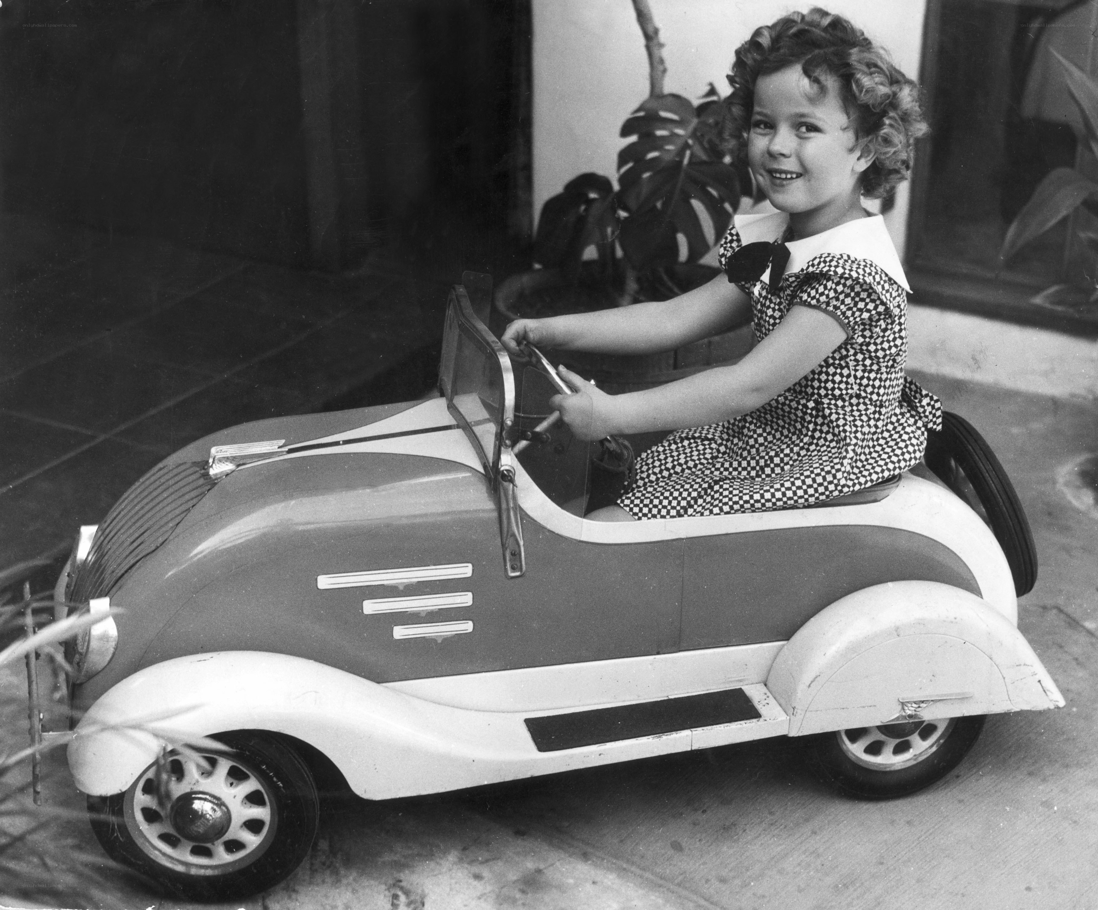 child in toy car