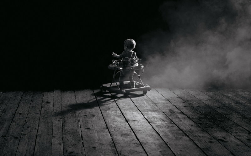Child in walker in dark room