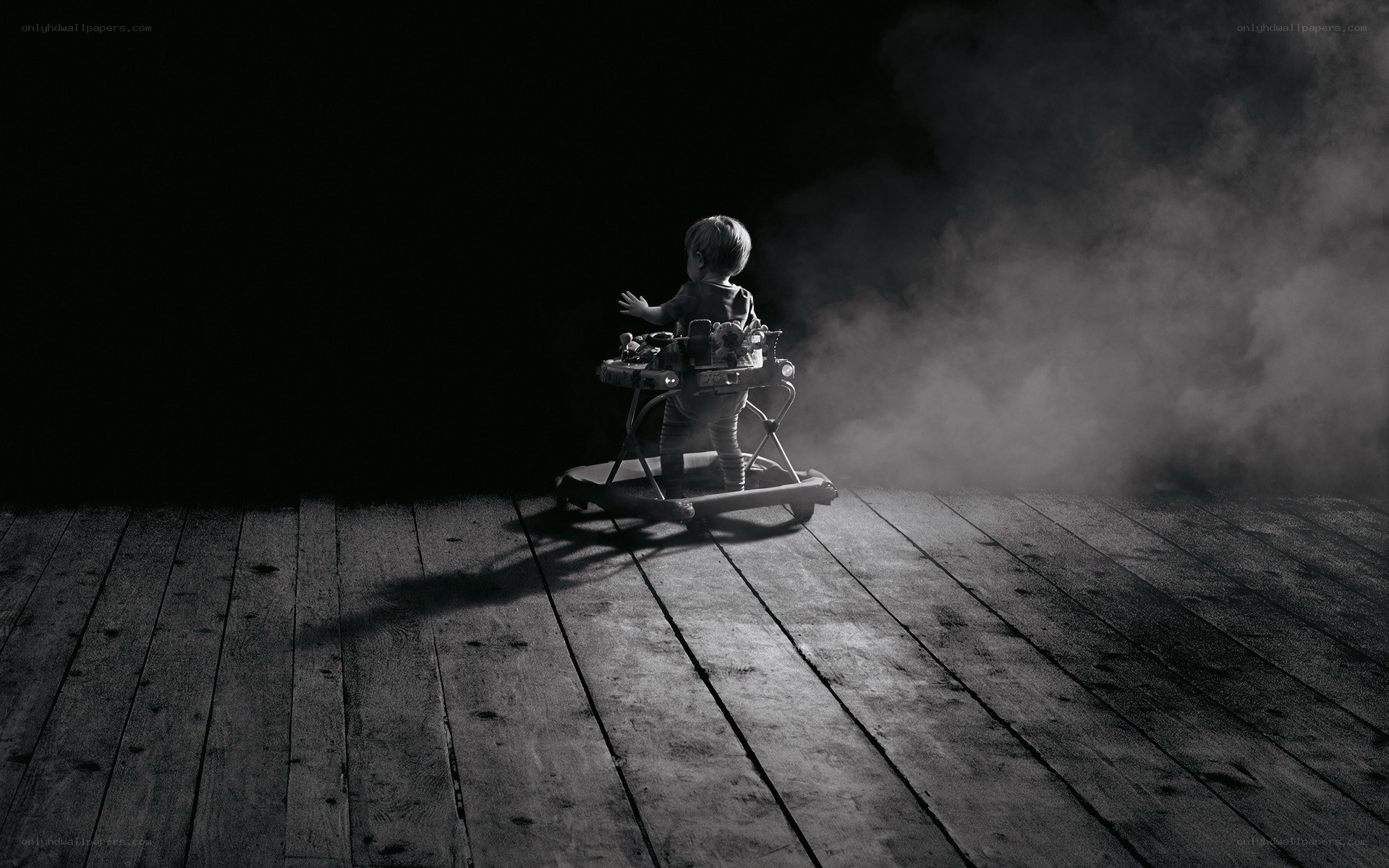 Child in walker in dark room