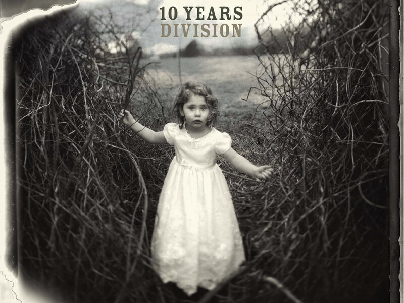 child in white dress among branches