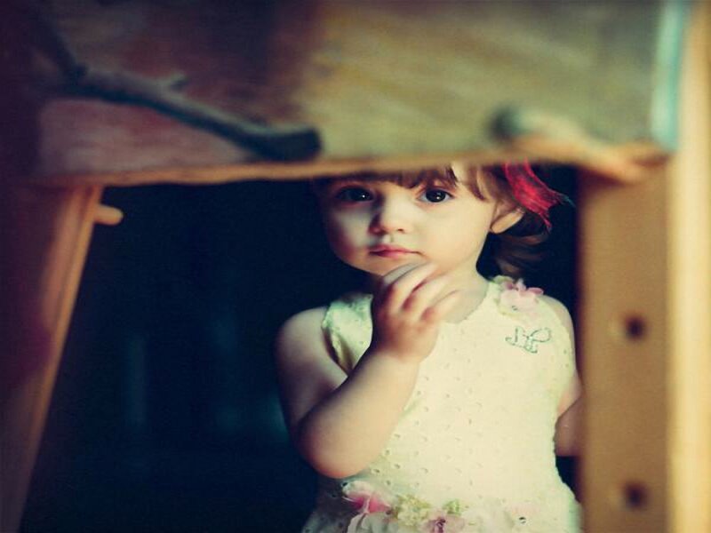 Child in White Dress — Thoughtful