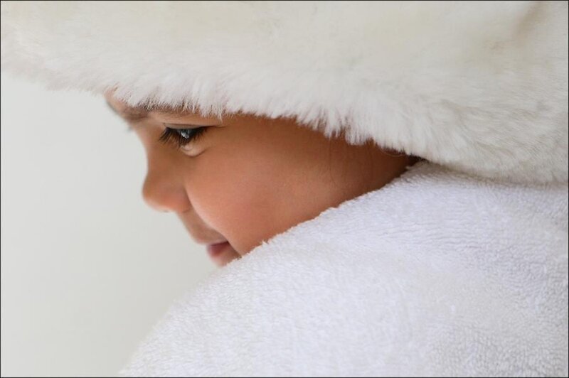 child in white fur hat