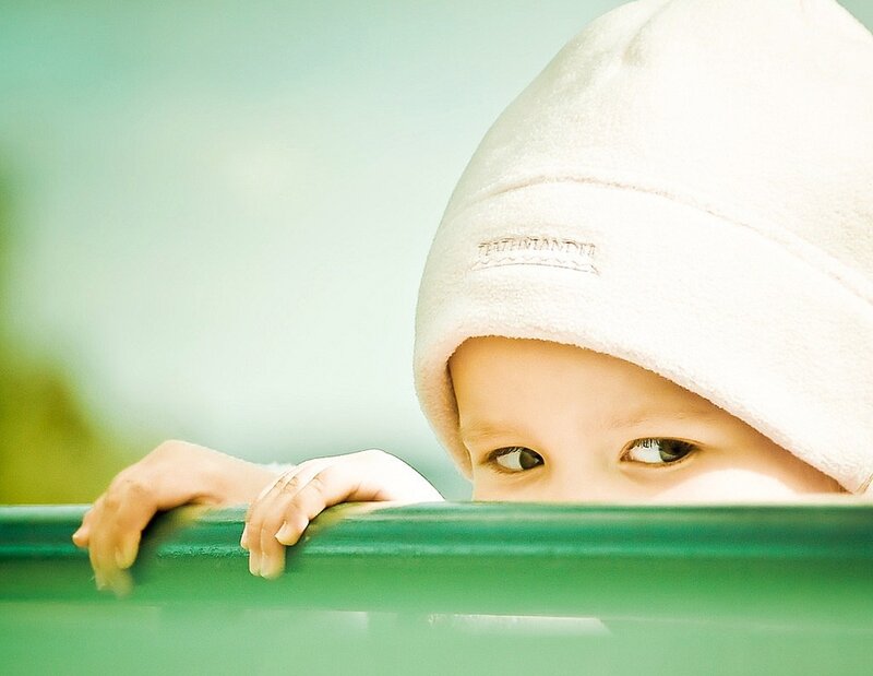 Child in White Hat — Curious