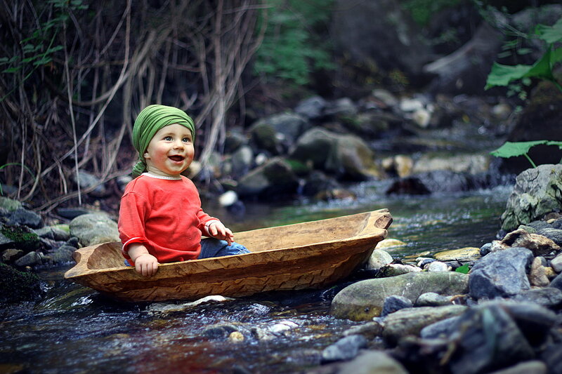 Child in Wooden Boat