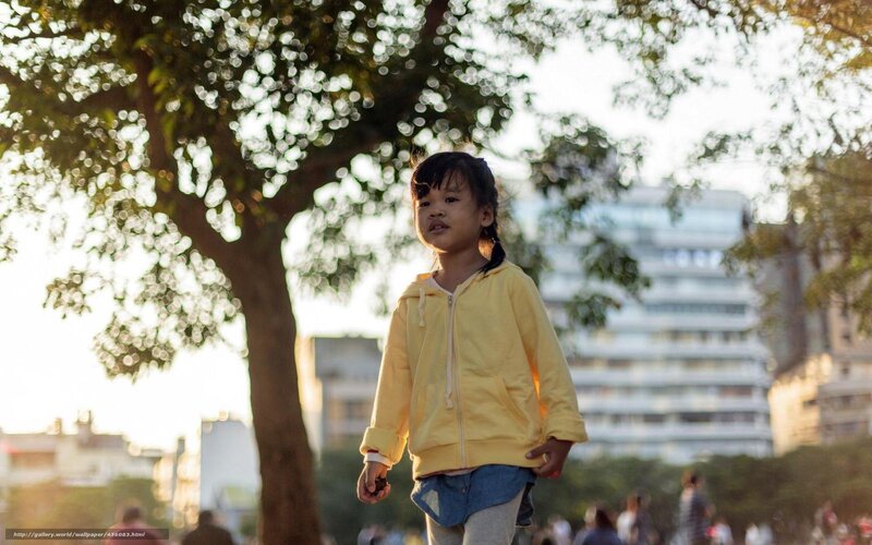 Child in yellow hoodie at park