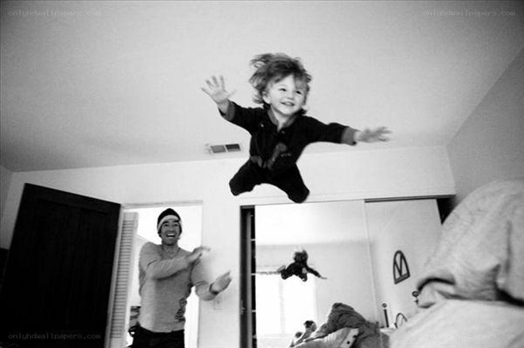 child jumping on bed