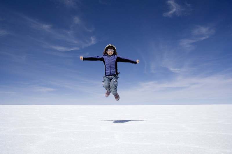 Child jumping on salt flat
