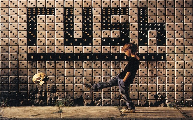 Child kicking skull against dice wall