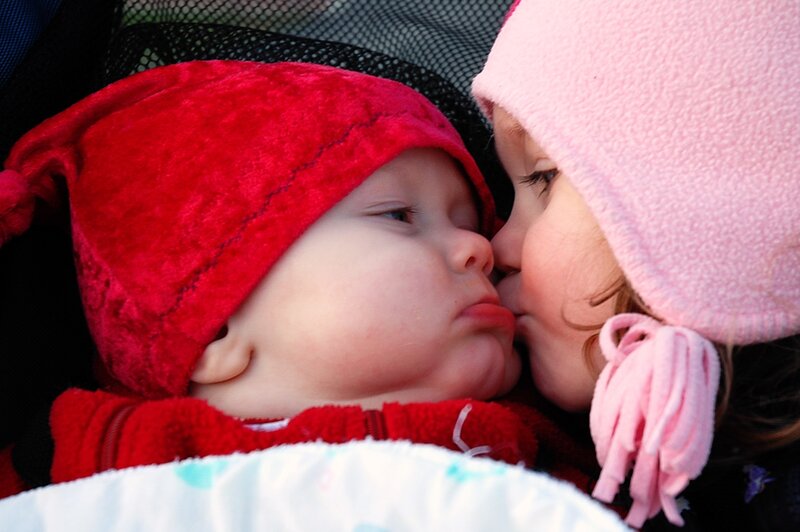 child kissing baby