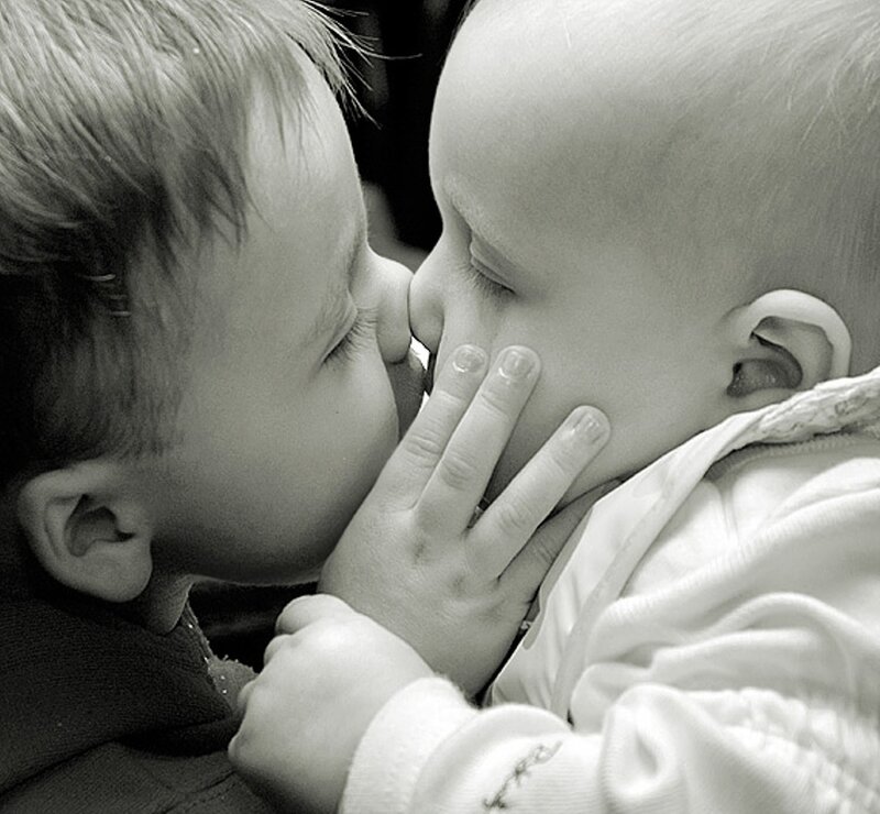 child kissing baby