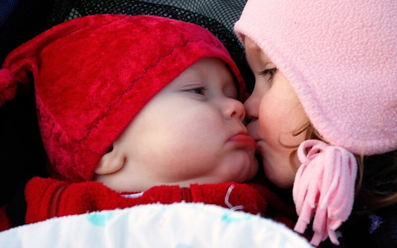 child kissing baby