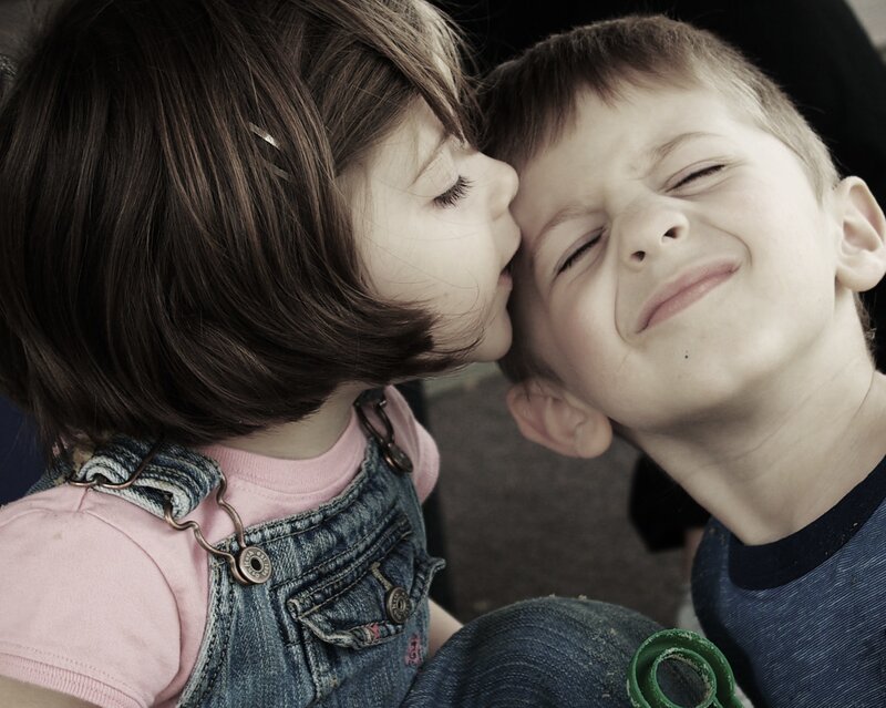 child kissing boy on cheek