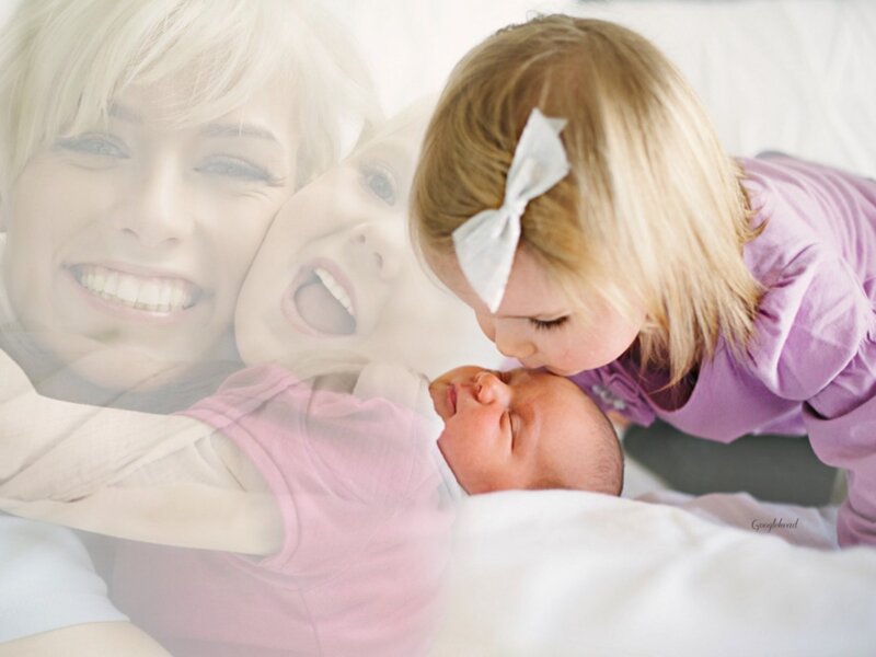 Child Kissing Newborn Baby