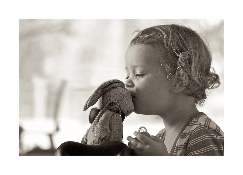 Child Kissing Stuffed Rabbit