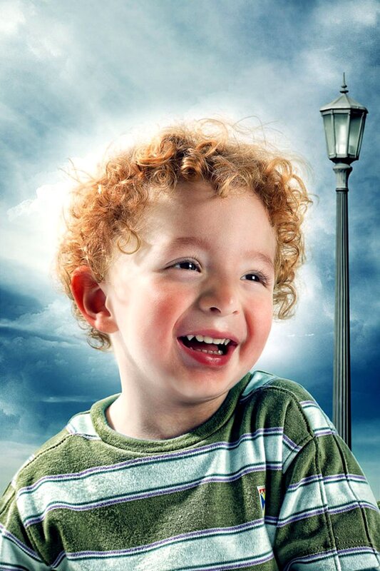 child laughing under cloudy sky