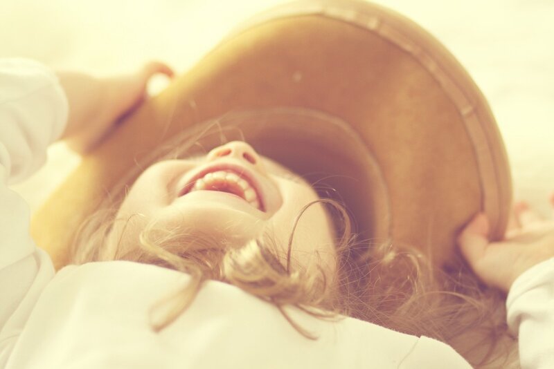 child laughing with hat