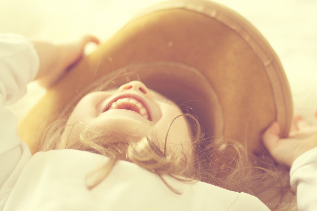 child laughing with hat