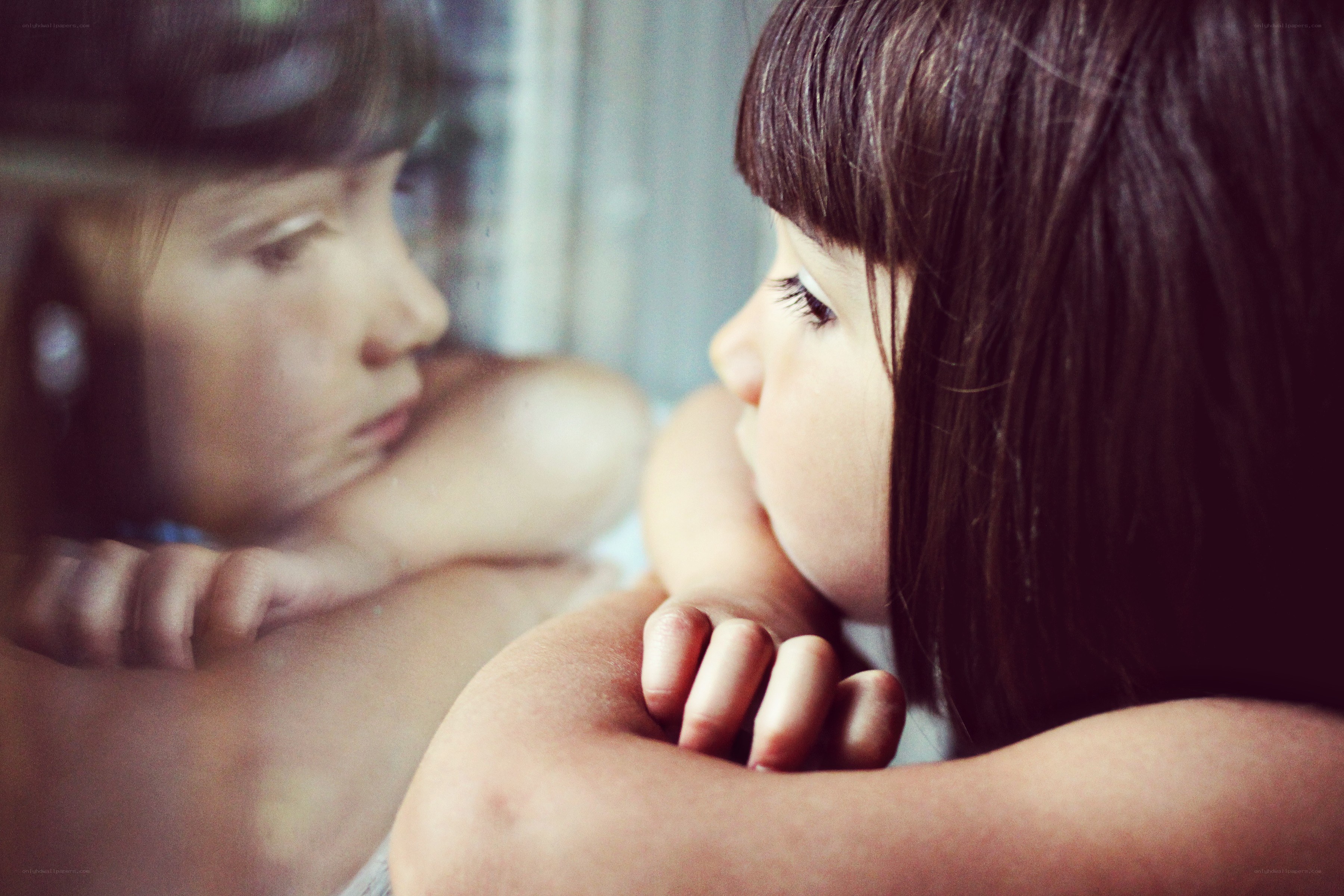 child looking at reflection