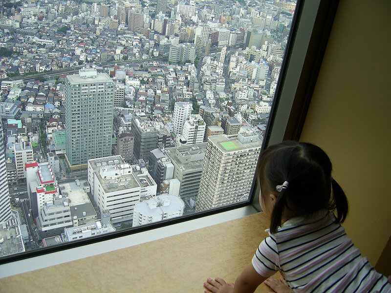 Child Looking Out Window — Beige