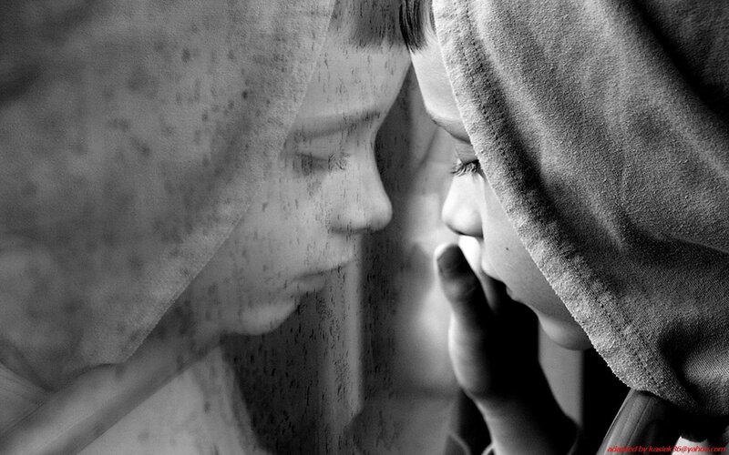 child looking through glass