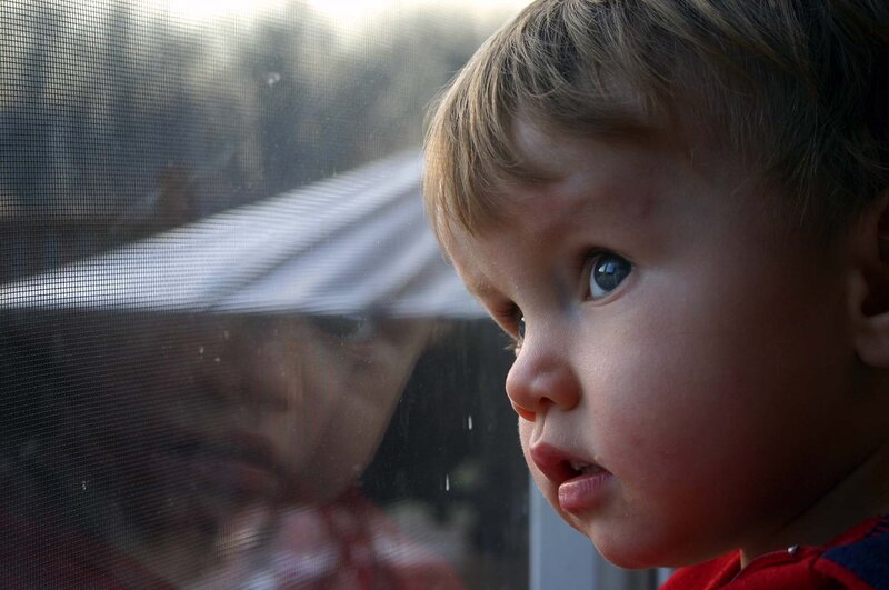 Child Looking Through Window — Red