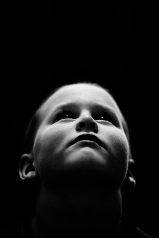 child looking up in darkness