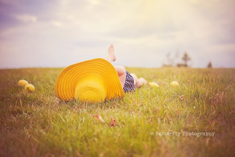 Child Lying in Grass — Green, Serene, Afternoon, Photograph, Yellow Hat