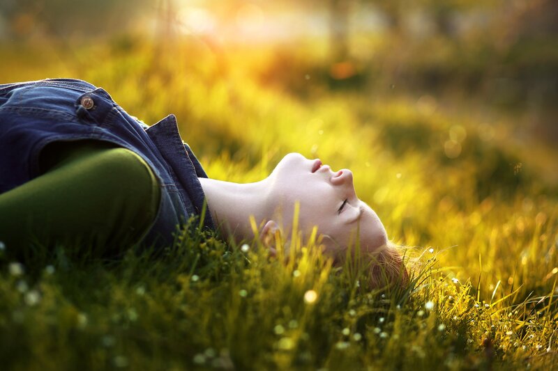 Child Lying in Grass — Green, Serene, Sunset