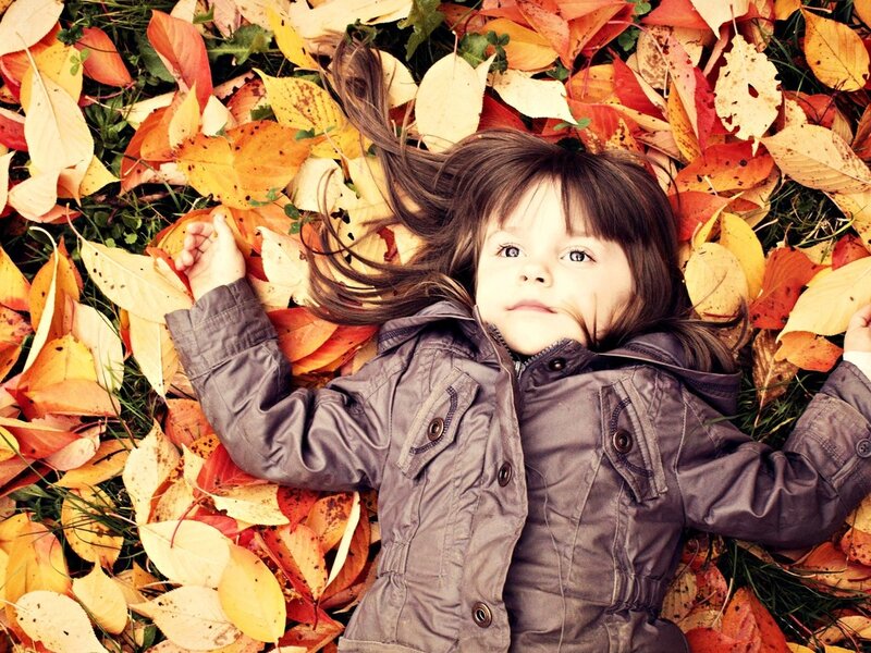 Child Lying in Leaves — Brown