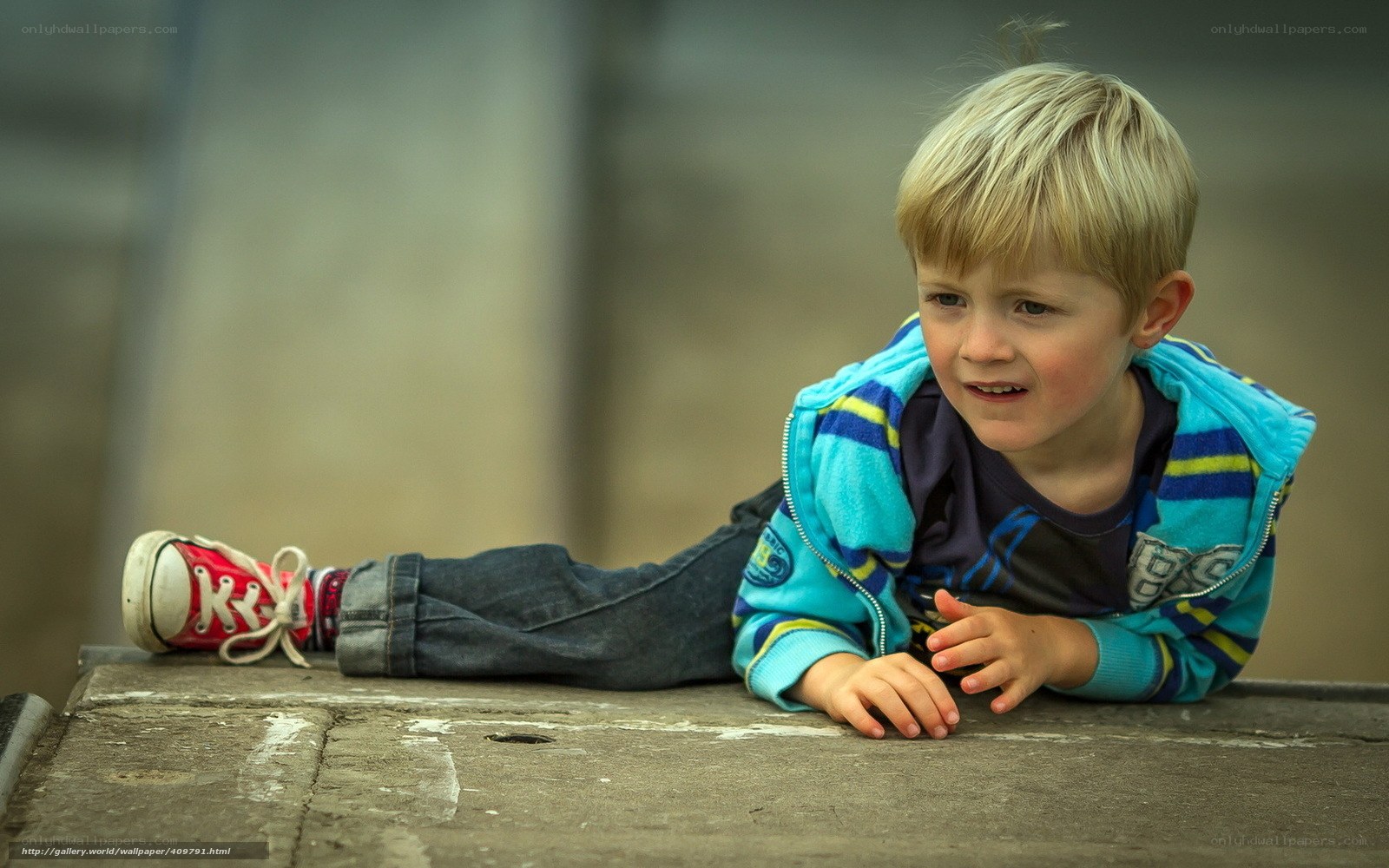 child lying on concrete