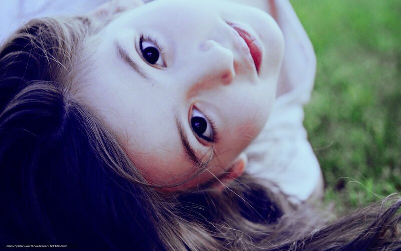 child lying on grass