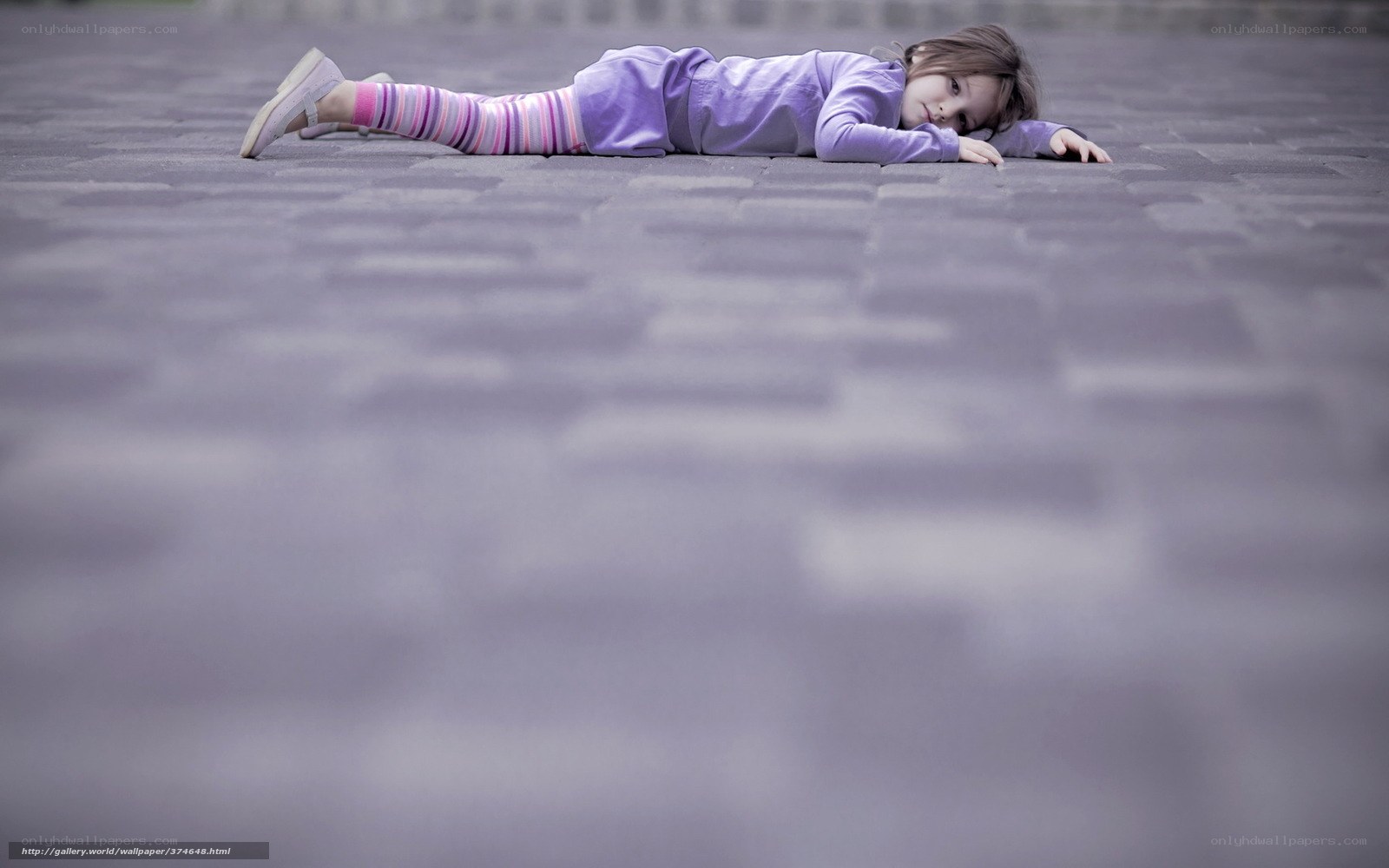 child lying on pavement