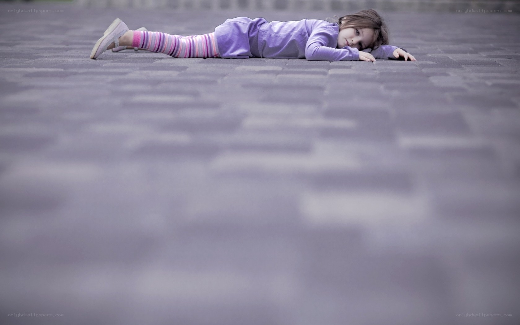 child lying on pavement