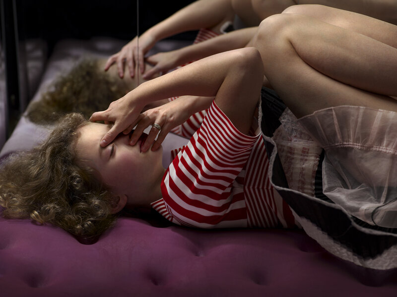 Child Lying on Purple Surface