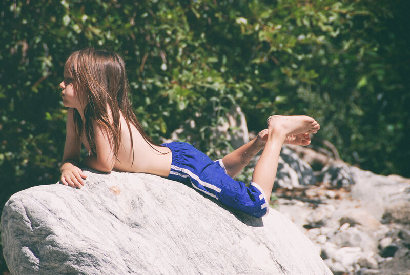 Child Lying on Rock