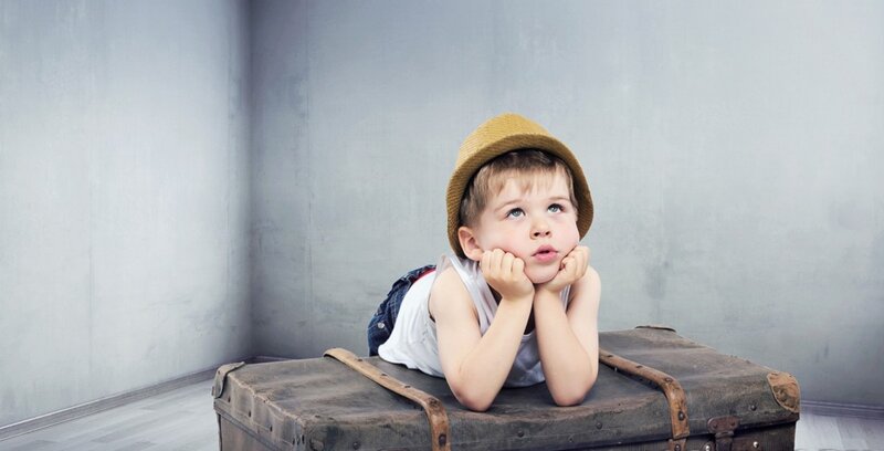 Child Lying on Suitcase