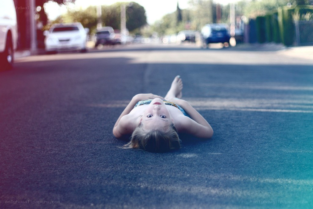 child lying on the street