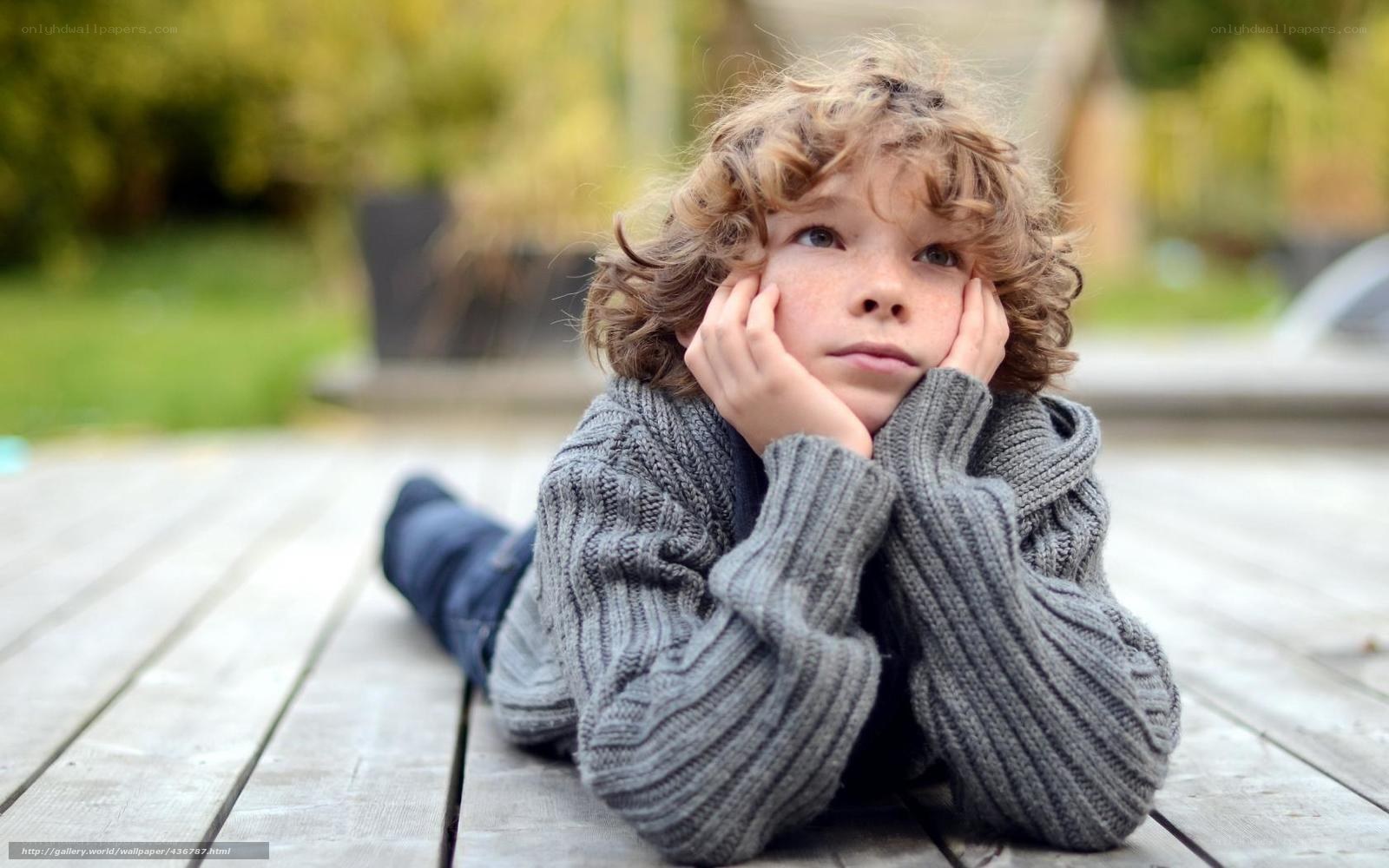 child lying on wooden deck