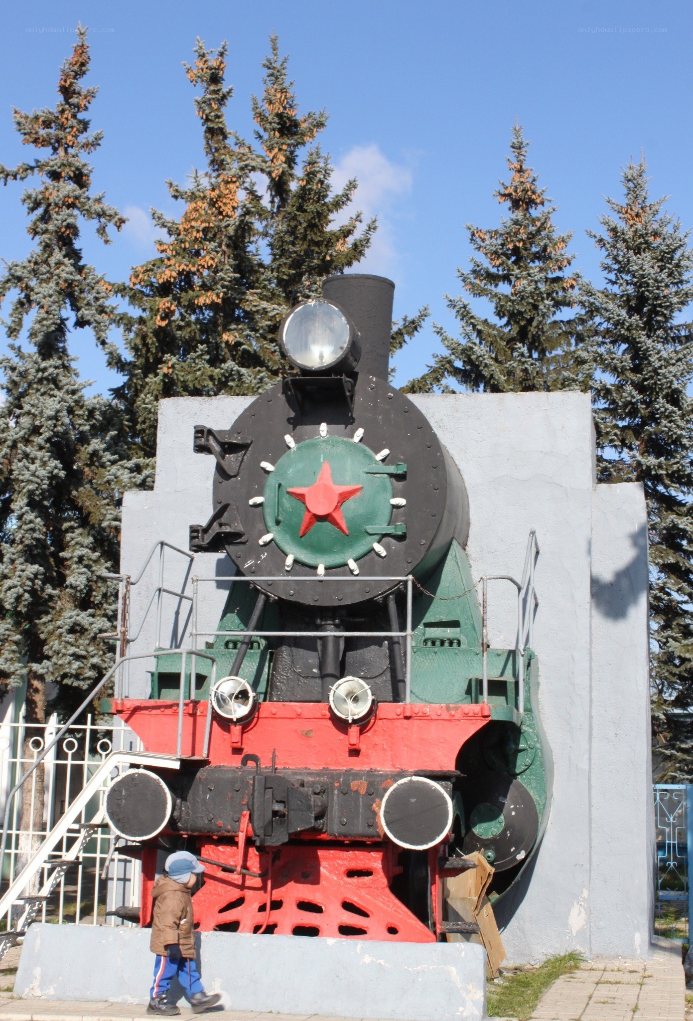 Child near a train monument
