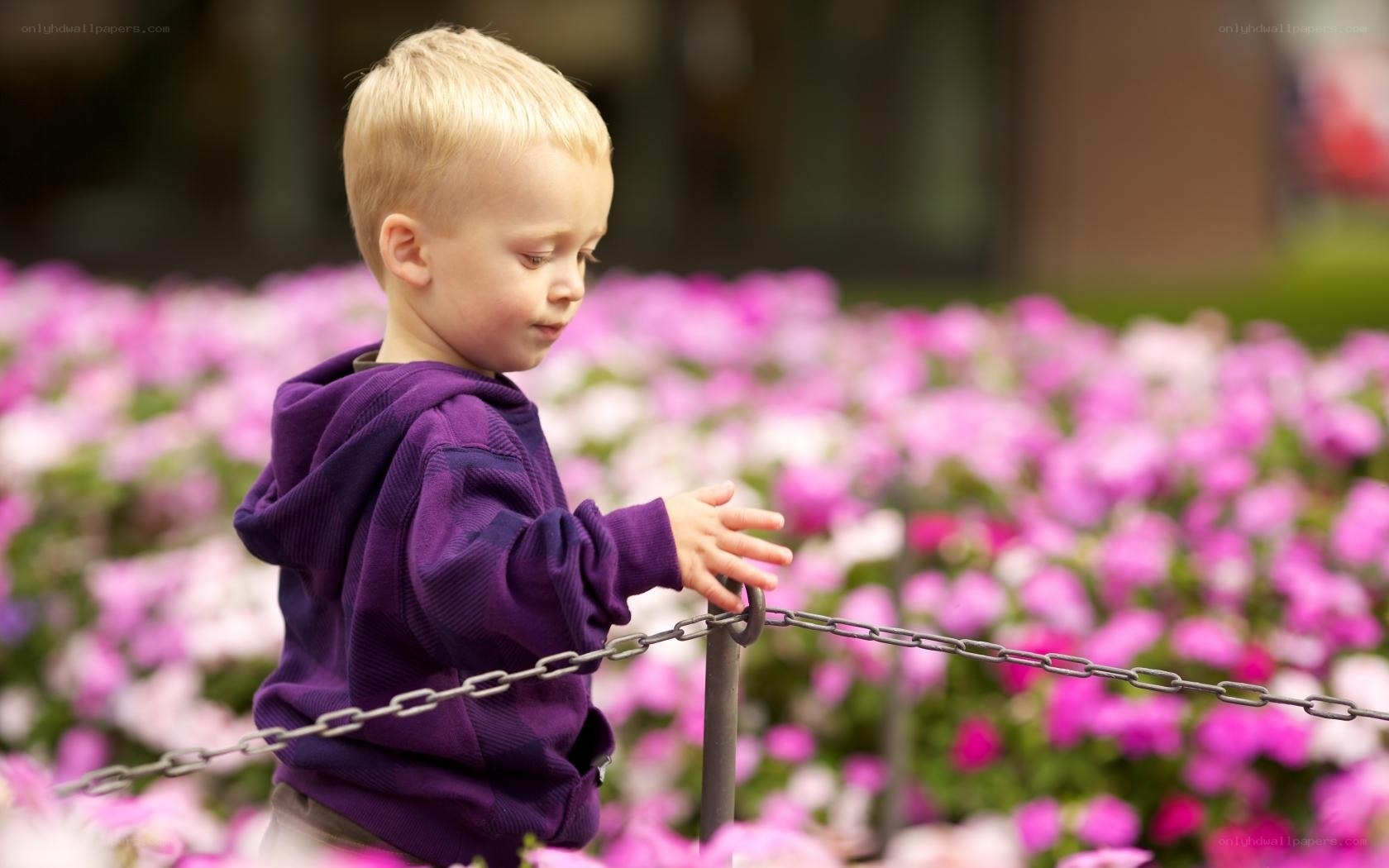 child near flower bed