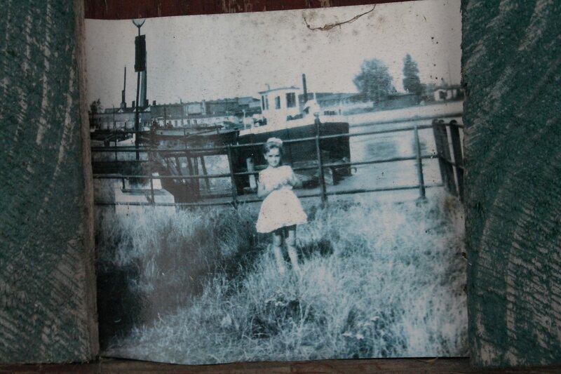 child near river with boat