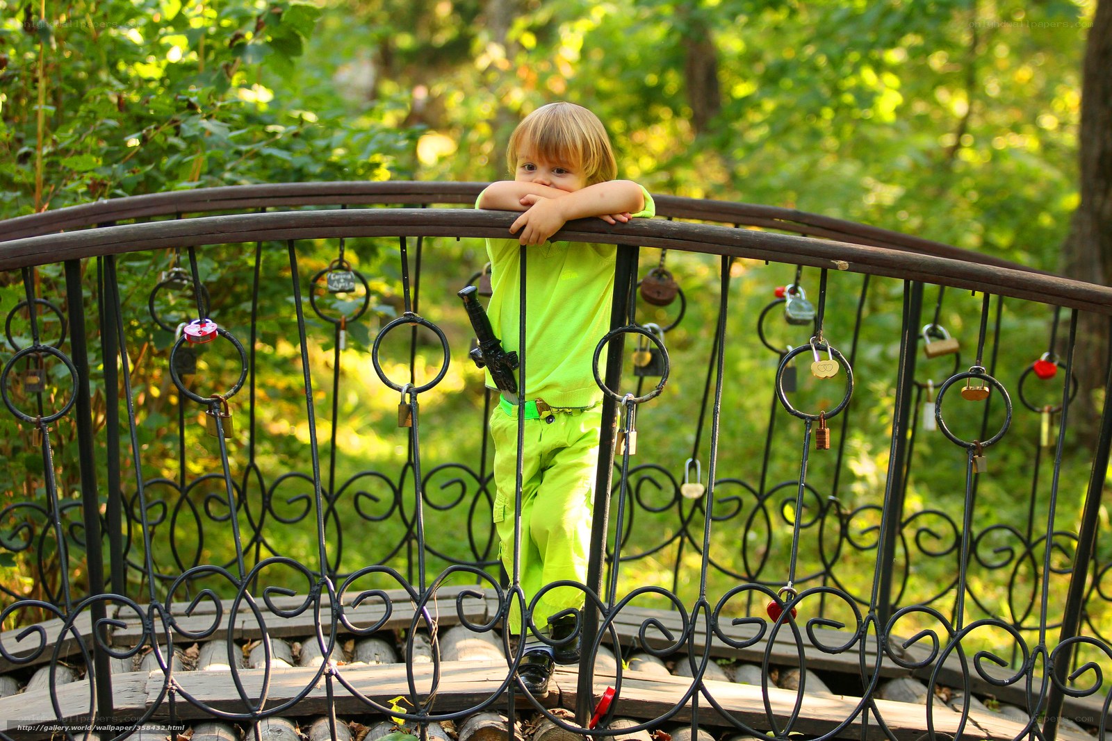 Child on a bridge with padlocks