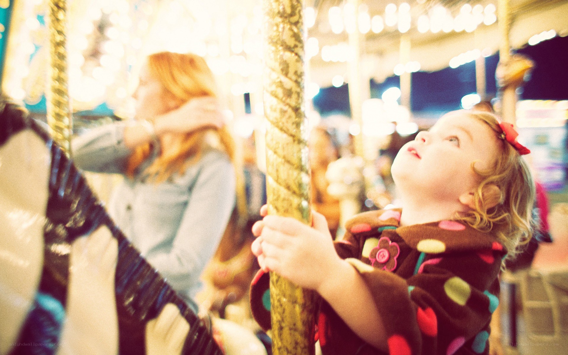 child on a carousel at night