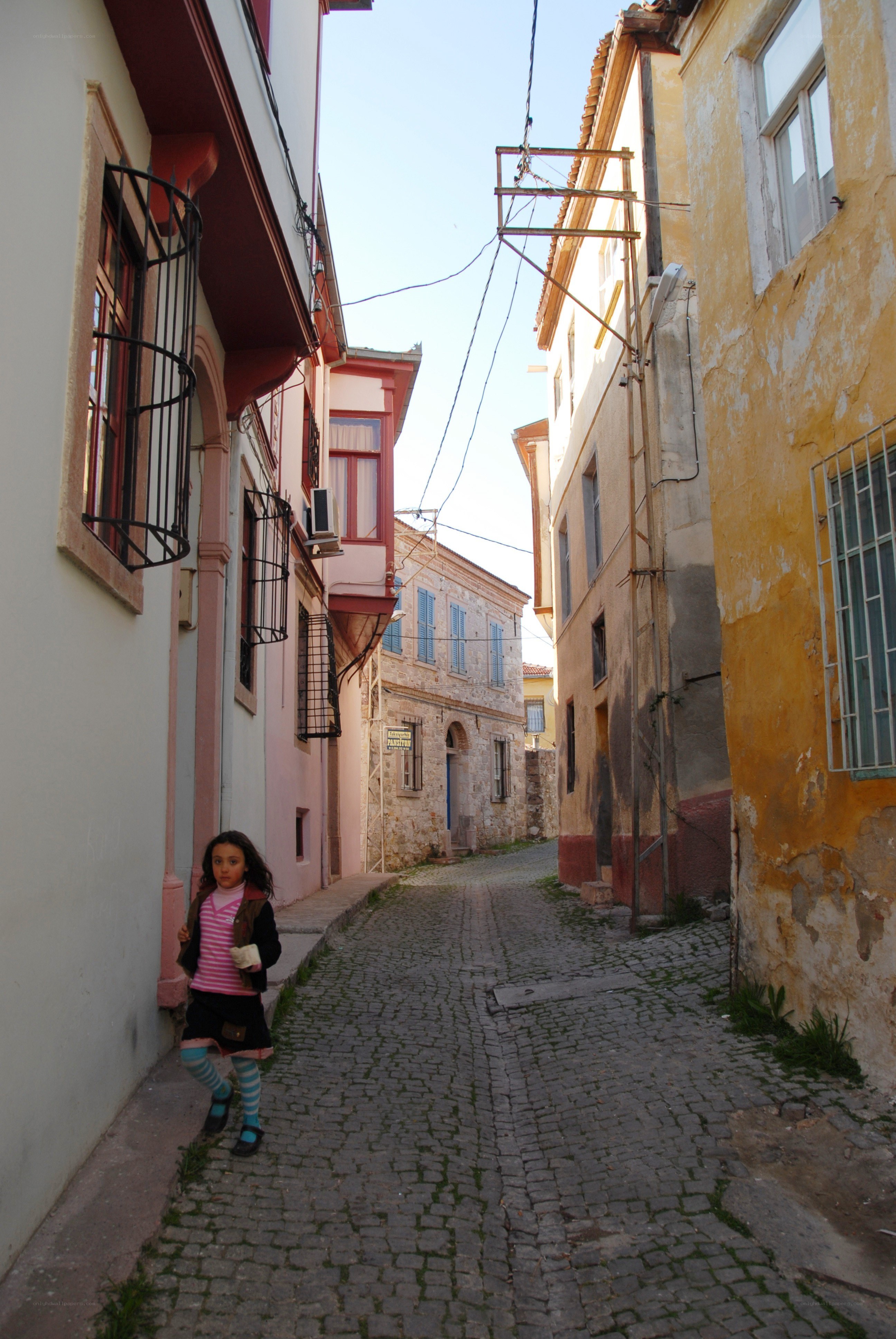 Child on a cobblestone street
