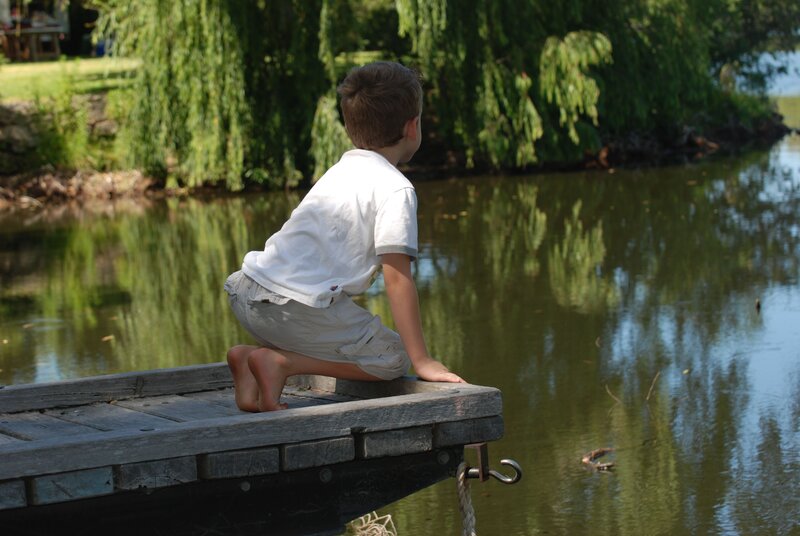 child on a dock by the water