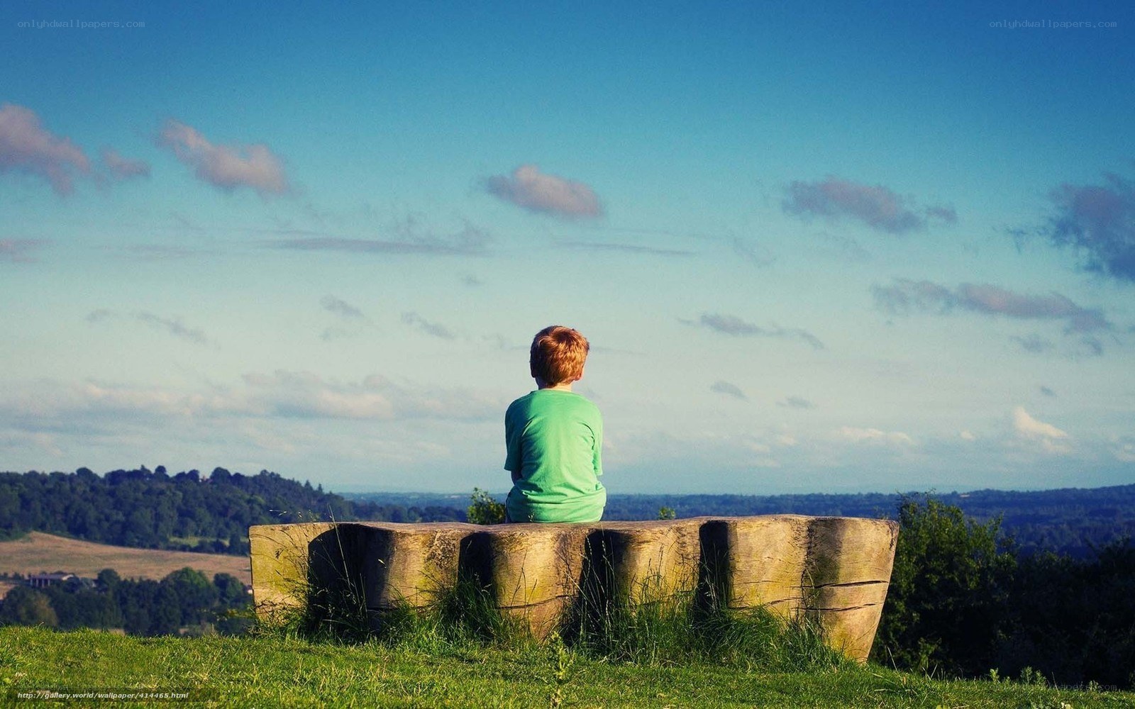 Child on a hill overlooking the valley
