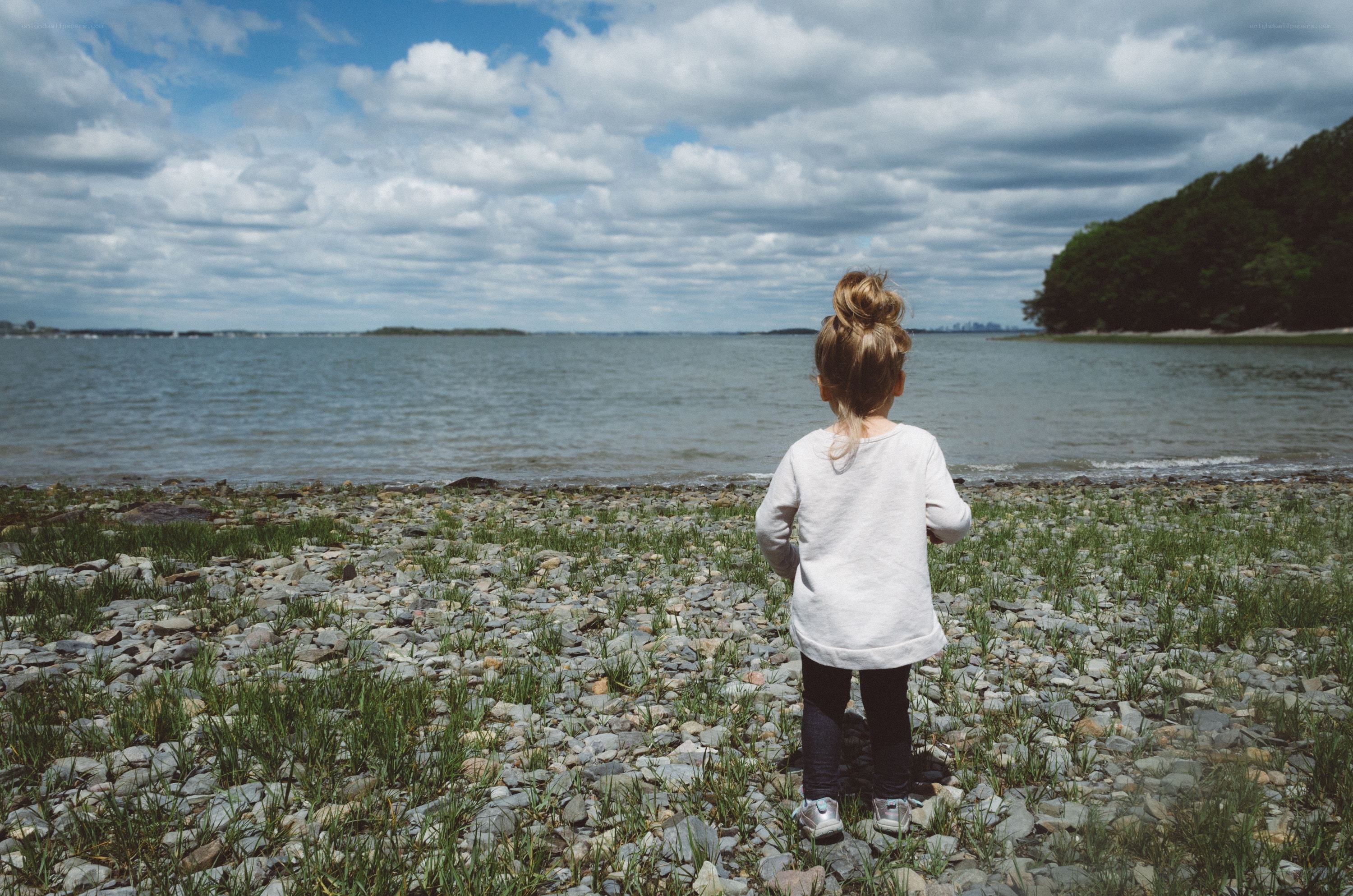 child on a rocky shore
