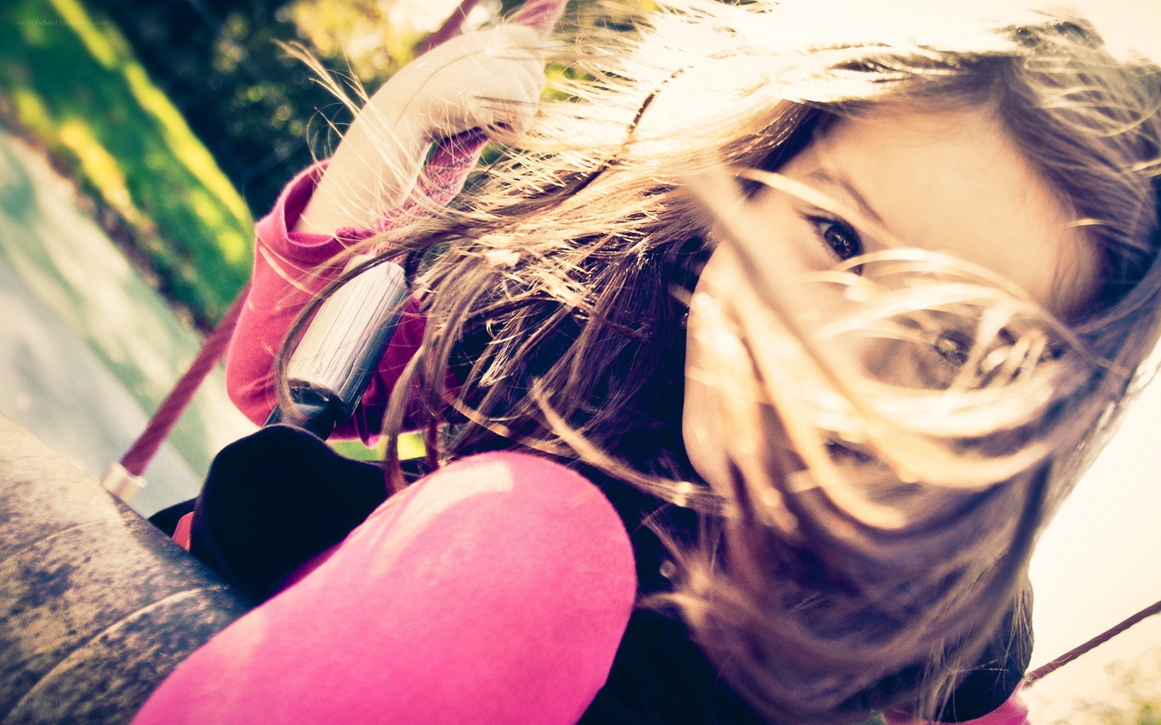 child on a swing in sunlight